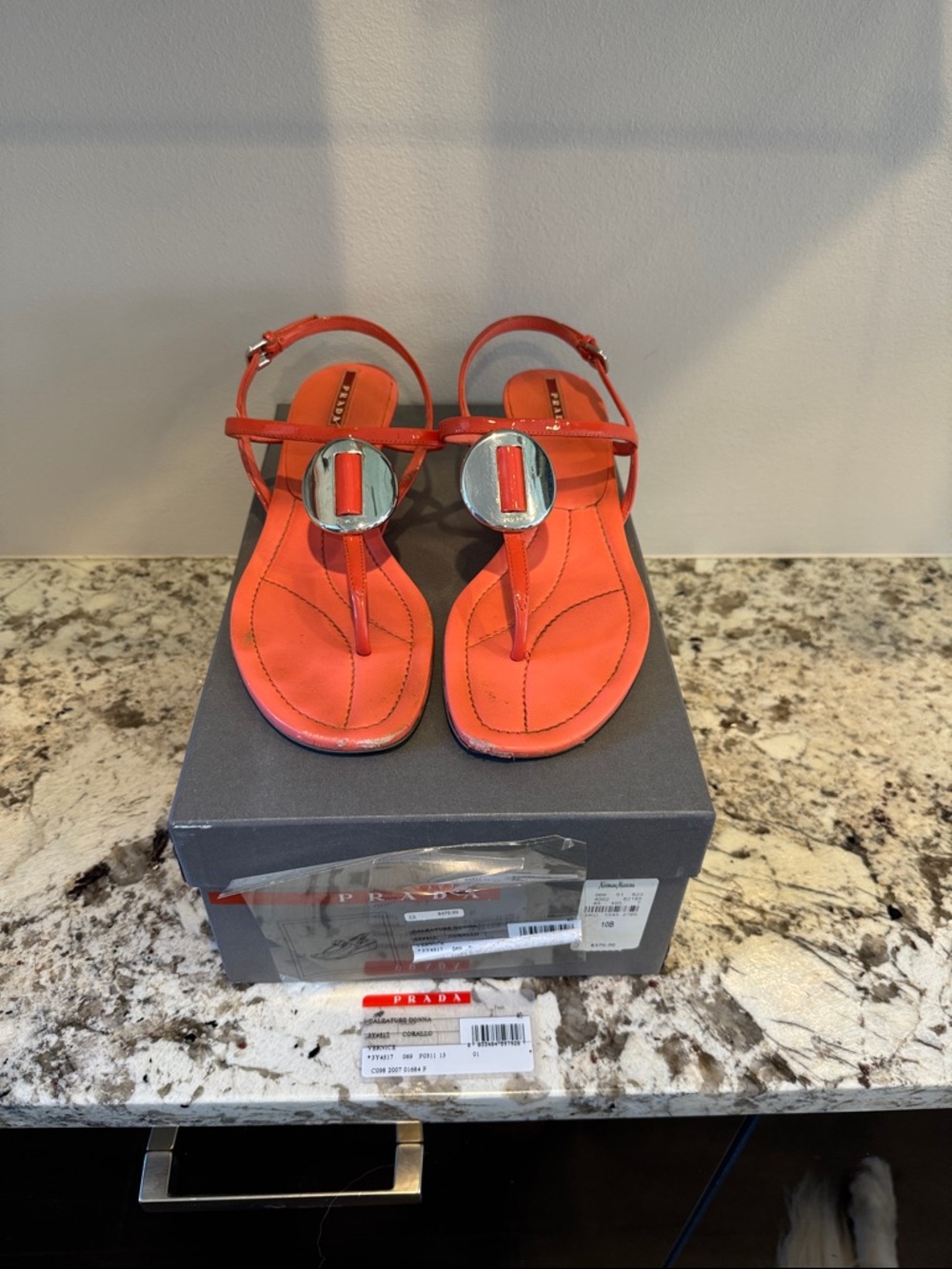 Prada Bright Orange T-Strap Sandals with Silver Medallion